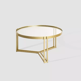 three-legged gold coffee table