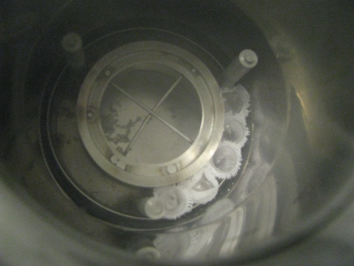 The experimental samples are loaded into a specially designed Dewar vessel, which will shortly be filled with liquid nitrogen and placed under gamma radiation. Note that the fire-sealed test tubes are wrapped in cotton cloth to keep them together because the test tubes become buoyant in the liquid nitrogen and begin to float in the Dewar vessel, interfering with proper radiation exposure.