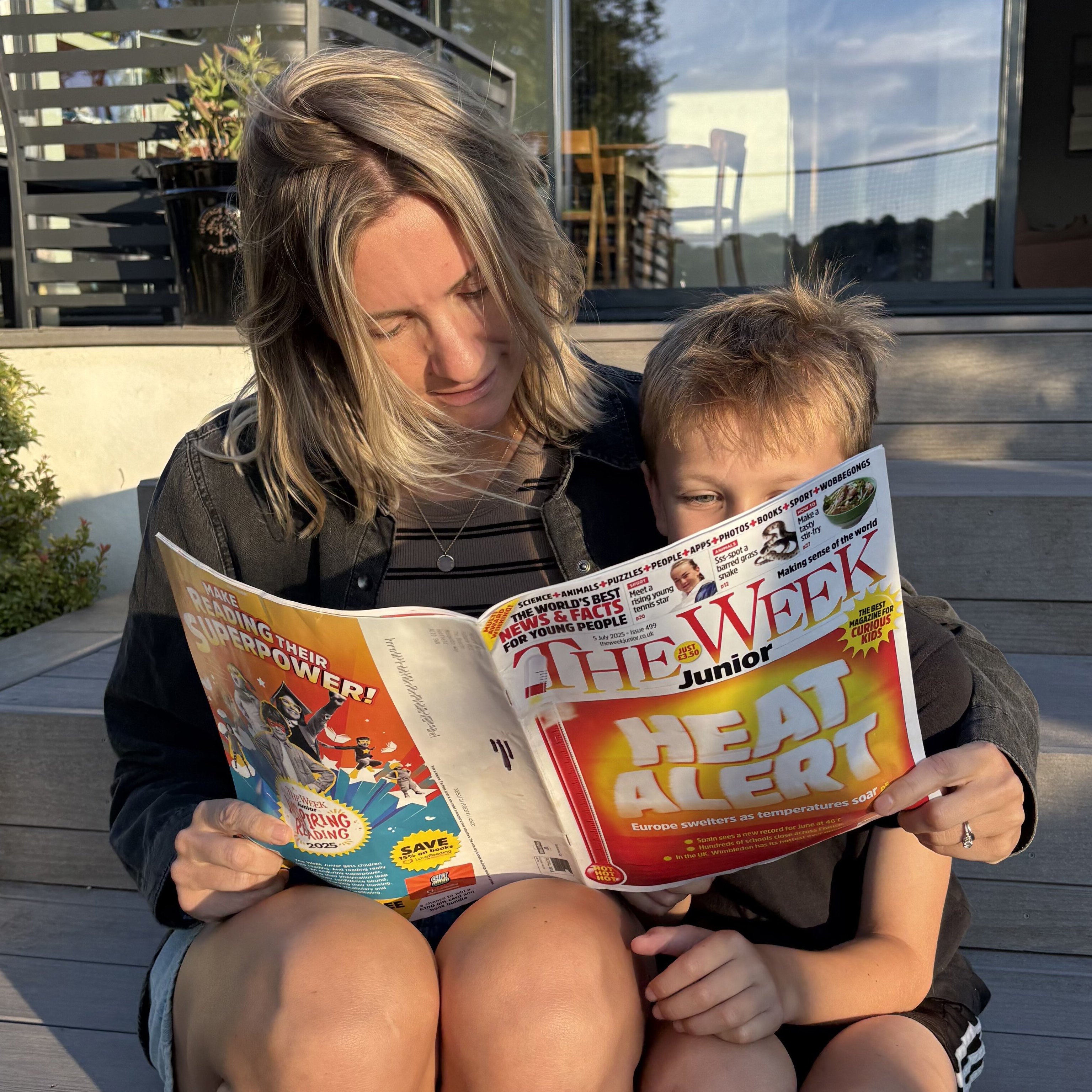 Sarah and her son reading The Week Junior