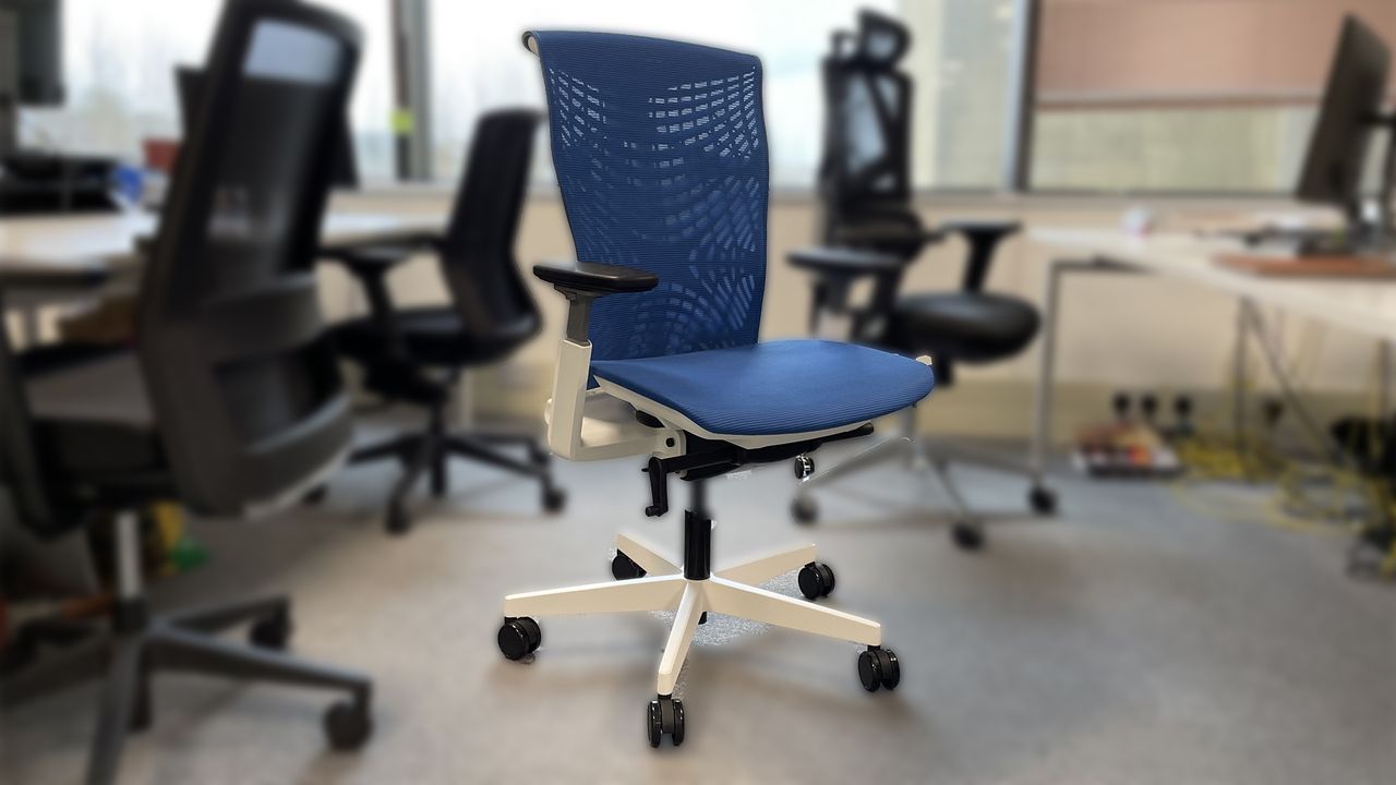 The Autonomous chair, in blue, in an office setting.