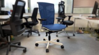 The Autonomous chair, in blue, in an office setting. 