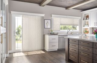 White cellular shades as door and window treatments in open plan white kitchen