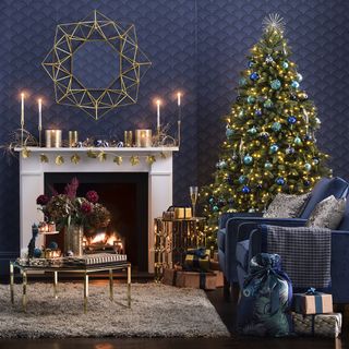 White mantelpiece, with a large decorated Christmas tree