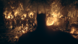 Batman standing in front of fire and rioters