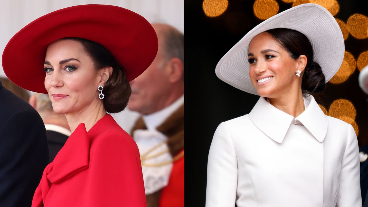 Kate Middleton wearing a red coat with a big bow and a huge red hat and Meghan Markle wearing a white coat and matching hat with gold dots behind her