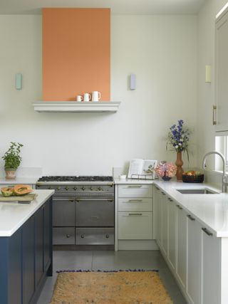 white kitchen with orange feature