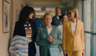 I Care A Lot Eiza Gonzalez and Rosamund Pike smile while flanking Dianne Wiest