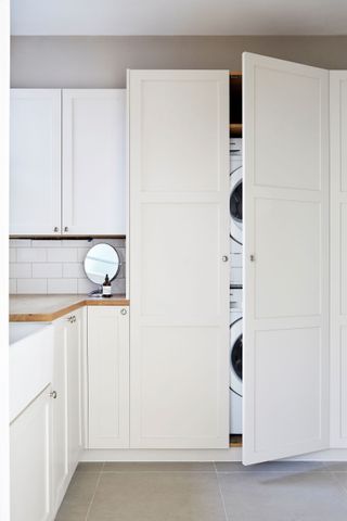 A double cabinet door with the inside unevenly spaced allows room for appliances