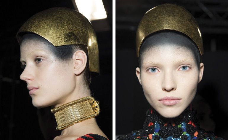 Sarah Burton&#039;s girls at Alexander McQueen looked like beautiful sculptures, their heads concealed under a golden helmet, their hairlines sprayed in black paint