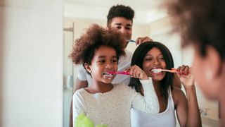 MetLife Dental Insurance review: A family brushes their teeth together