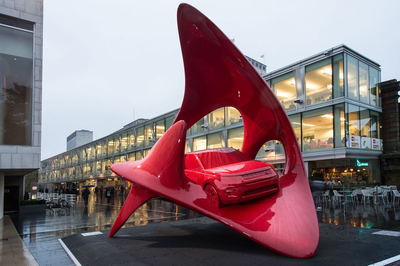 Red art sculpture of land rover 