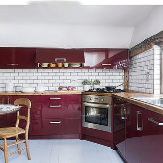 kitchen with wooden flooring and wine colour cabinet