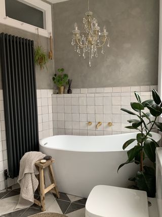 industrial concrete bathroom with traditional chandelier by Kerry Lockwood