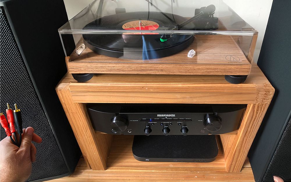 A wooden rack full of hi-fi components