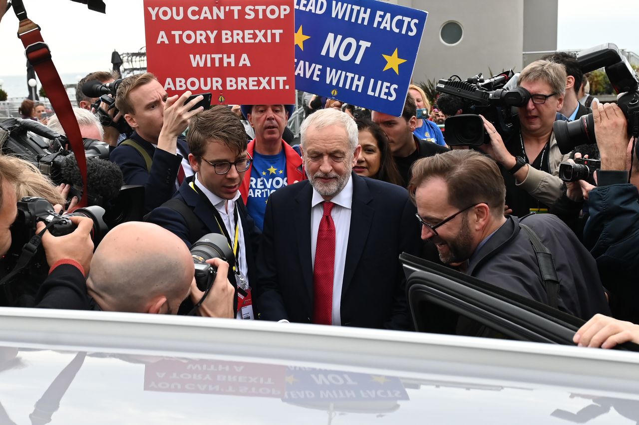 Britain&amp;#039;s main opposition Labour Party leader Jeremy Corbyn (C) leaves after an interview with the BBC during the Labour party conference in Brighton, on the south coast of England on Septemb