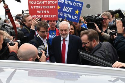 Britain's main opposition Labour Party leader Jeremy Corbyn (C) leaves after an interview with the BBC during the Labour party conference in Brighton, on the south coast of England on Septemb