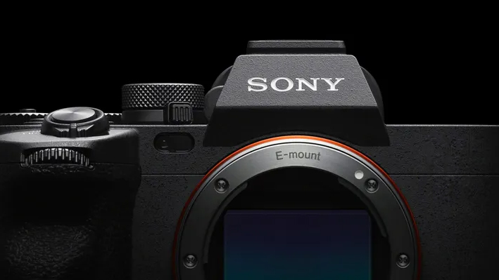 Close-up of a Sony camera featuring the E-mount and top dial, highlighting its sleek design and advanced photography features