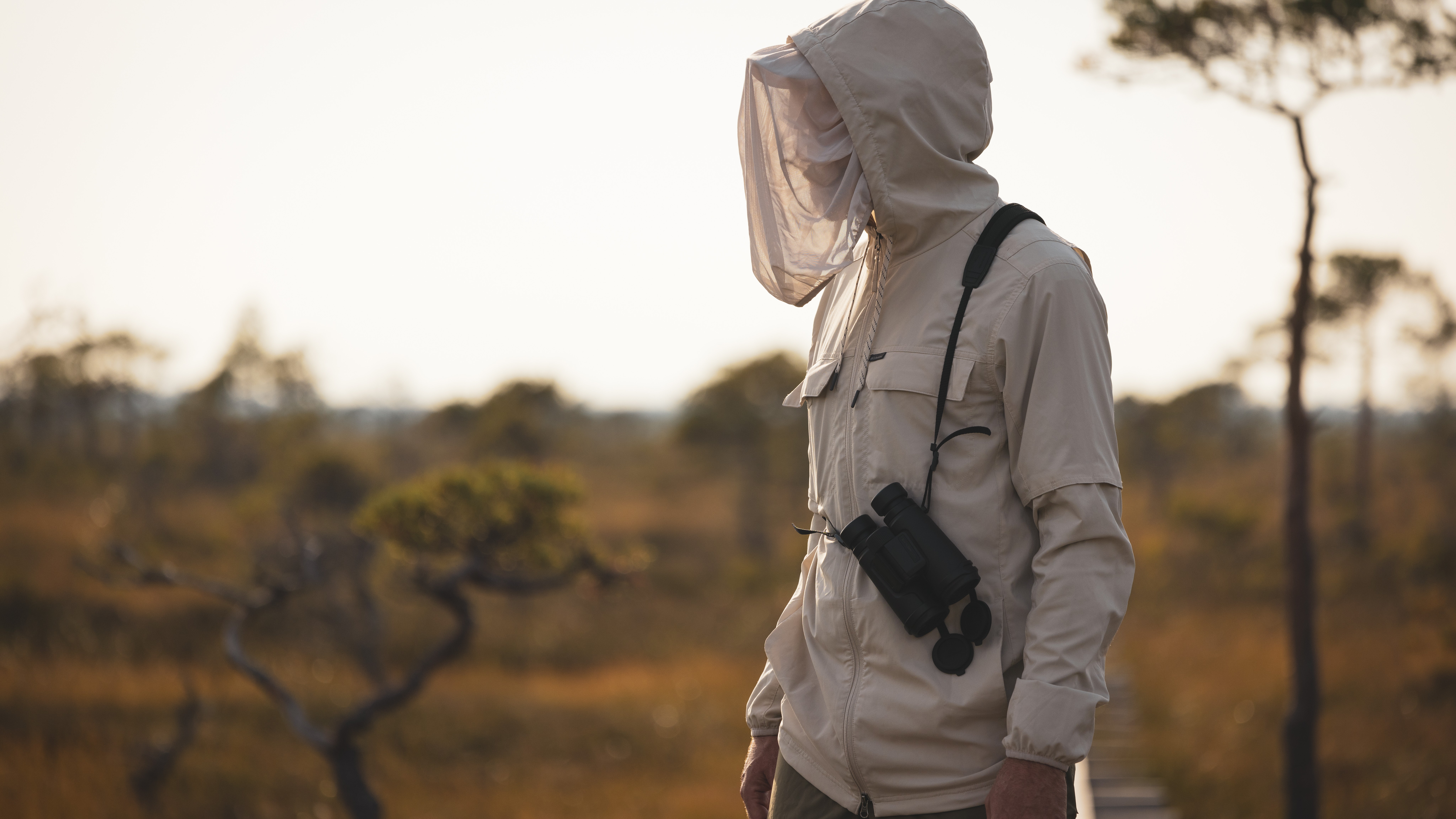 A hiker wearing a hooded jacket from Columbia's Insect Shield collection