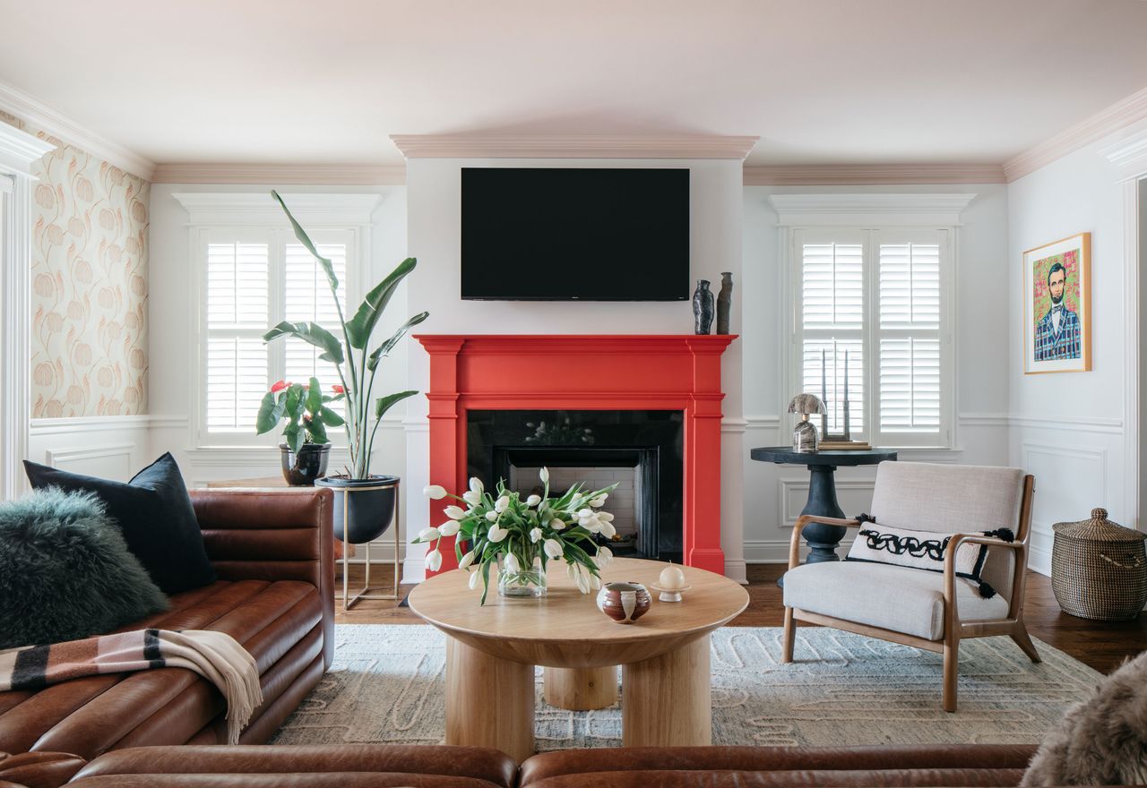 a living room with a red painted fireplacw