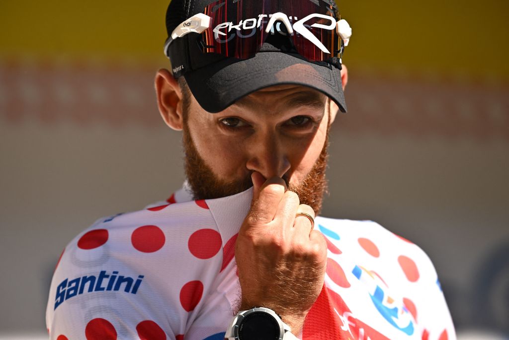 Cofidis teams German rider Simon Geschke celebrates on the podium with the climbers dotted jersey after the 9th stage of the 109th edition of the Tour de France cycling race 1929 km between Aigle in Switzerland and Chatel Les Portes du Soleil in the French Alps on July 10 2022 Photo by Marco BERTORELLO AFP Photo by MARCO BERTORELLOAFP via Getty Images