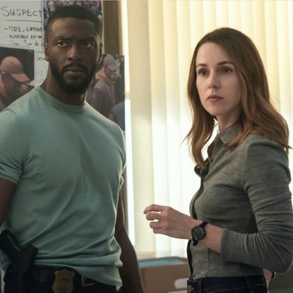  Alex Cross (Aldis Hodge) and Kayla Craig (Alona Tal) standing in front of a board full of photos and notes about a case in cross season 2