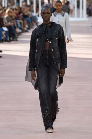 Model wears embellished jeans on the Chanel Spring/Summer 2025 runway.