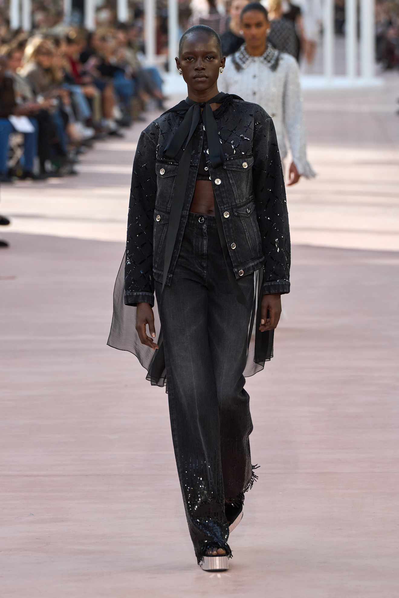 Model wears embellished jeans on the Chanel Spring/Summer 2025 runway.