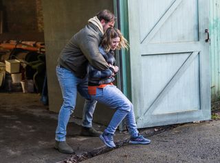 Dean grabs Abi Franklin and locks her in the garage.