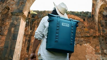 Best YETI coolers: person wearing a YETI cooler on his back