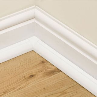 wooden flooring with white skirting board and plastic trunking to hide wires
