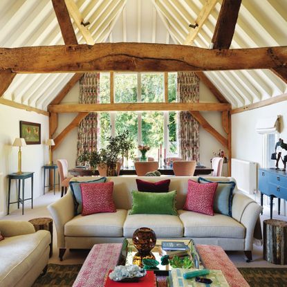 exterior of converted barn showing large windows and garden setting