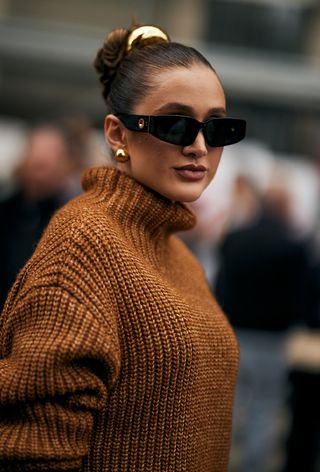 Milan fashion week spring 2025 street style photo of a woman wearing oversized jewelry trend