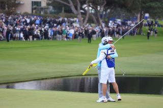 Homa hugs his caddie on the 18th green after winning