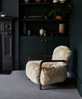 dark grey living room with comfy chair and dark grey carpet