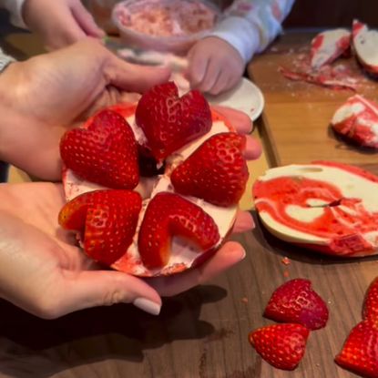 Princess Lilibet and Meghan Markle making strawberry bagels with heart shaped strawberries 