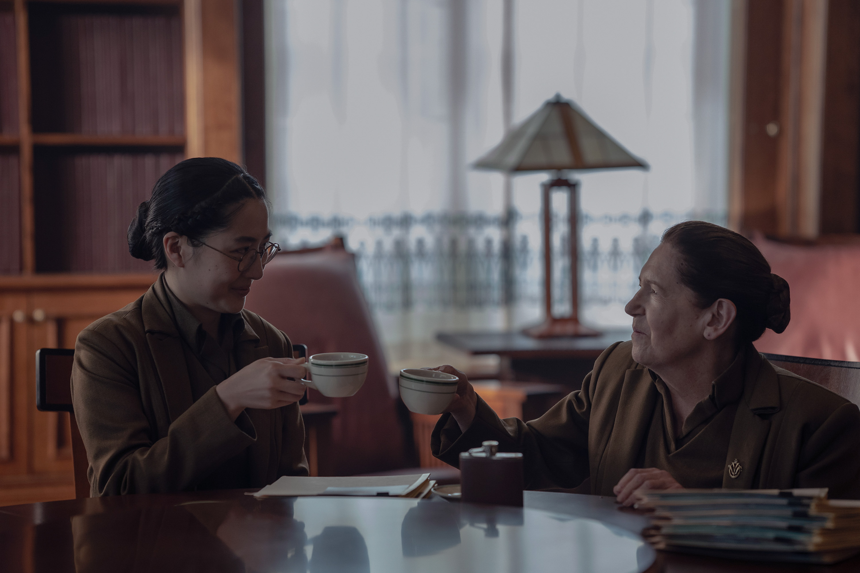 Aunt Vidala (Mabel Li) and Aunt Lydia (Ann Dowd) sit together in a scene from 'The Testaments.'