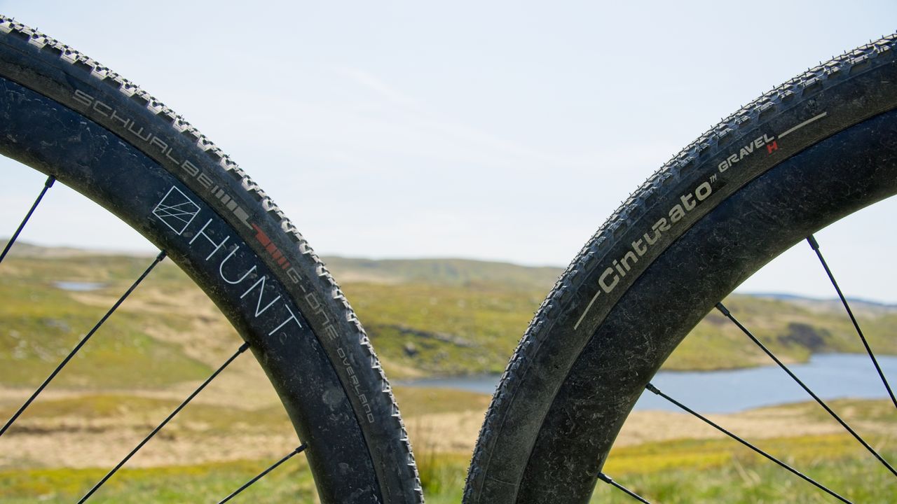 Schwalbe&#039;s G-One Overland tube style bike tire next to Pirelli&#039;s tubeless Cinturato Gravel H gravel bike tire on the Trans Cambrian Way in Wales