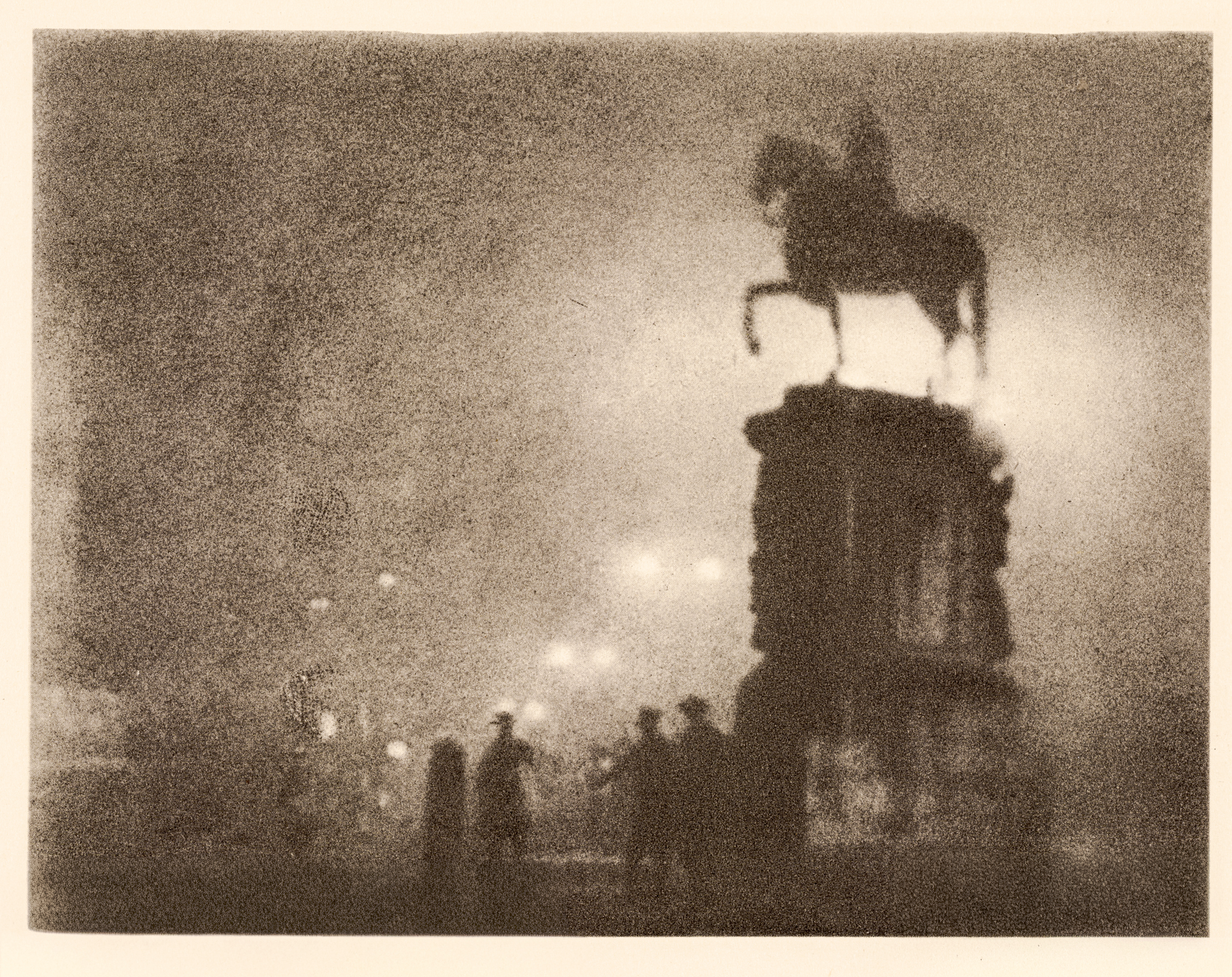 A misty photogravure of an equestrian statue silhouetted atop its plinth in Trafalgar Square, with several indistinct figures gathered at its base under diffuse night light.