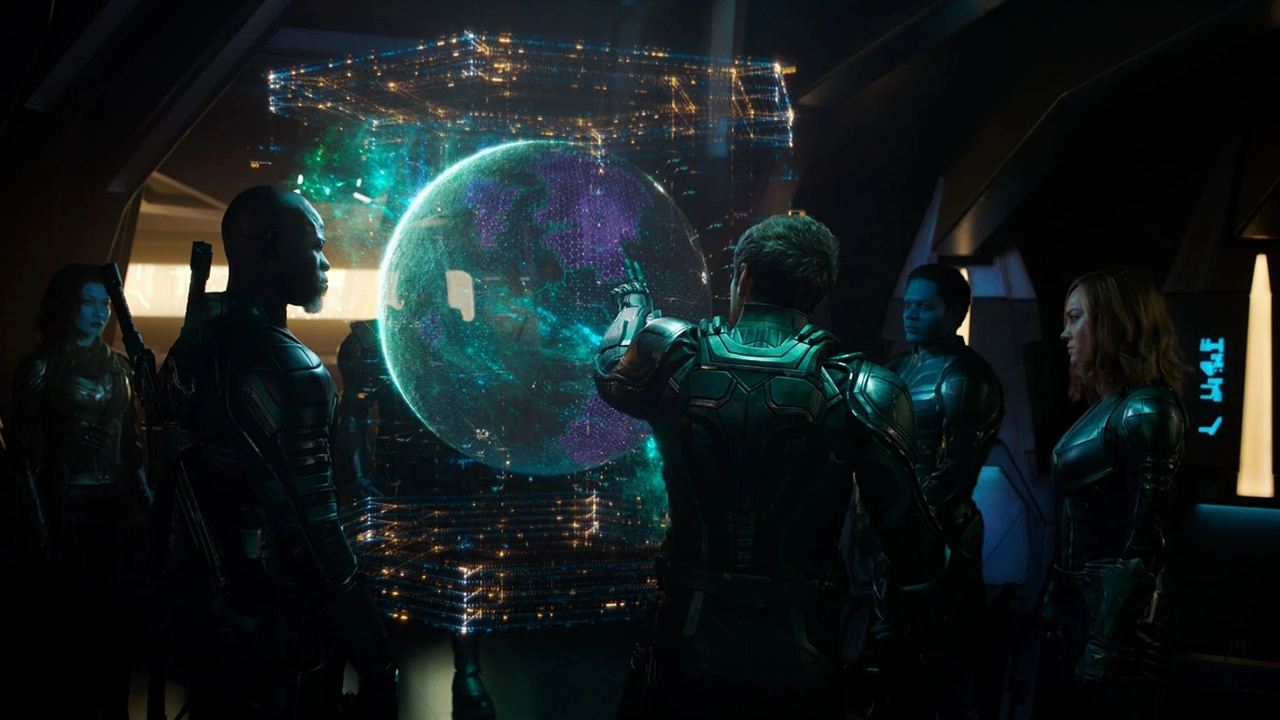 Starforce - 5 armored people standing and studying a hologram of Earth.