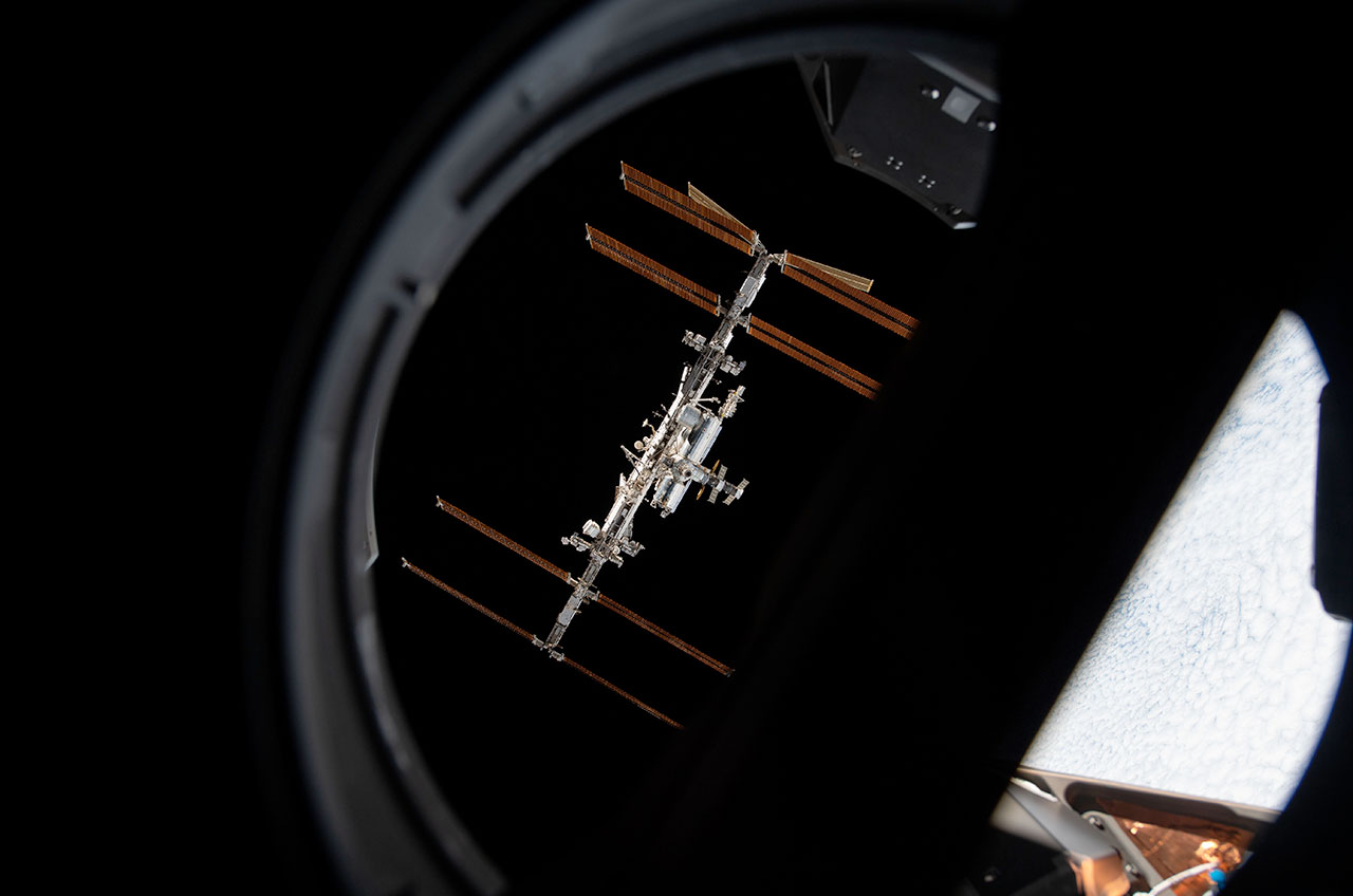 The International Space Station is pictured through a window aboard a SpaceX Crew Dragon during a tour of the orbiting complex in November 2021.