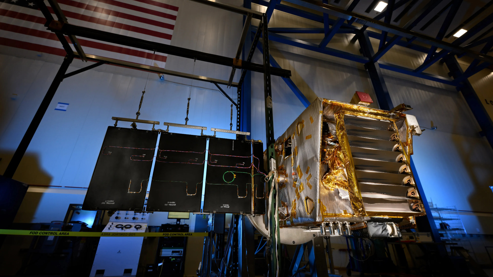 A small moon satellite with its solar panel unfurled during ground testing