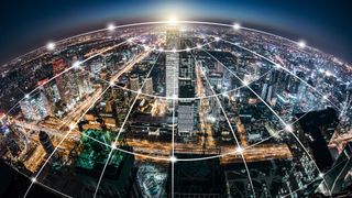 A digital grid criss-crossing the lights and buildings of a vast city below