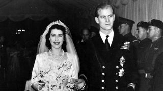 Queen Elizabeth and Prince Philip walk together on their wedding day in 1947