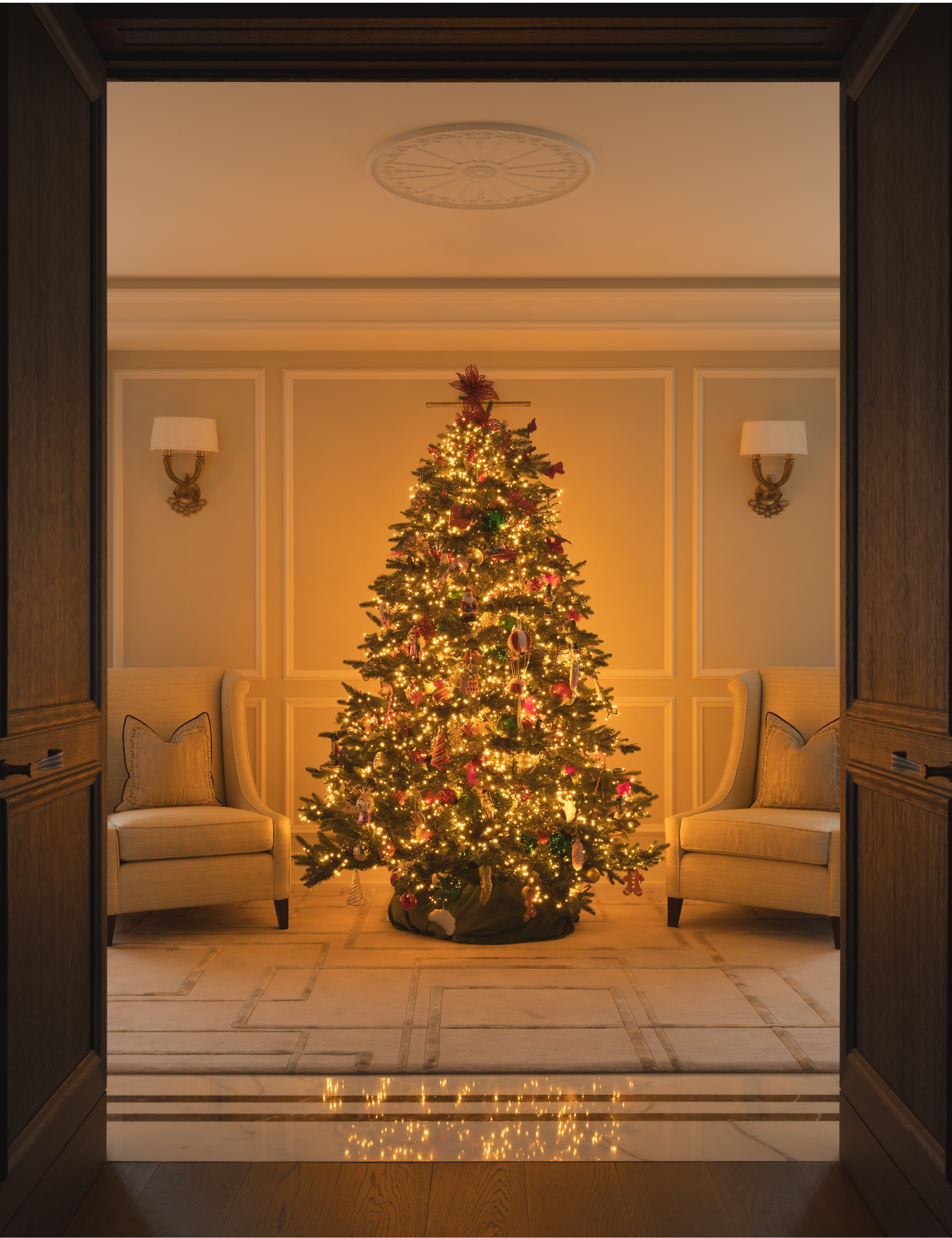 Large Christmas tree styled with warm LED lights and ornate ornaments