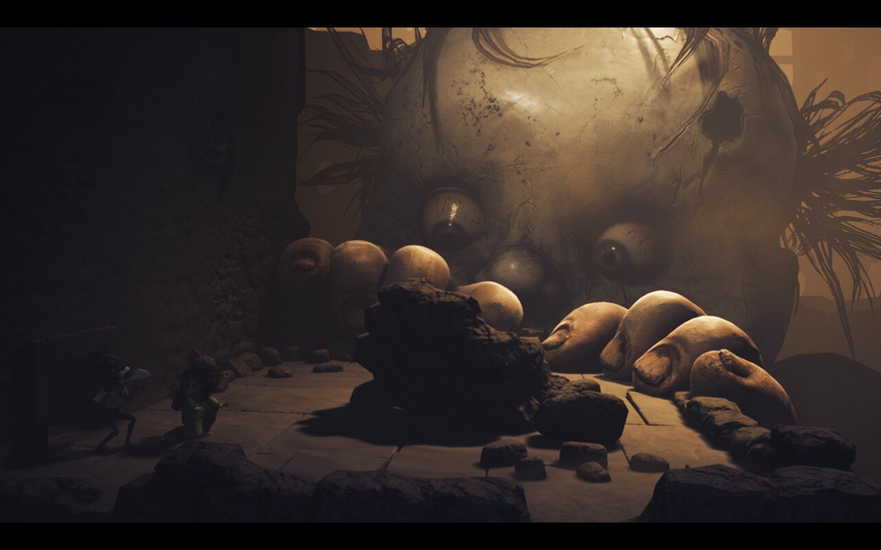 A giant living doll peeks over the wall of a ruin