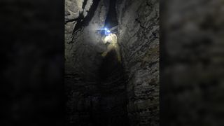 A caver exploring Australia's deepest cave.