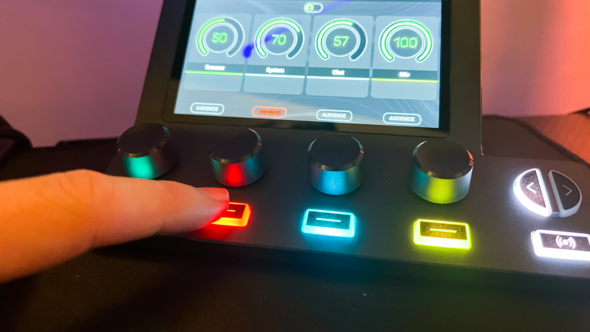 BEACN Mix Create review image with the various buttons displaying in different colours, with the reviewer pressing a red one.