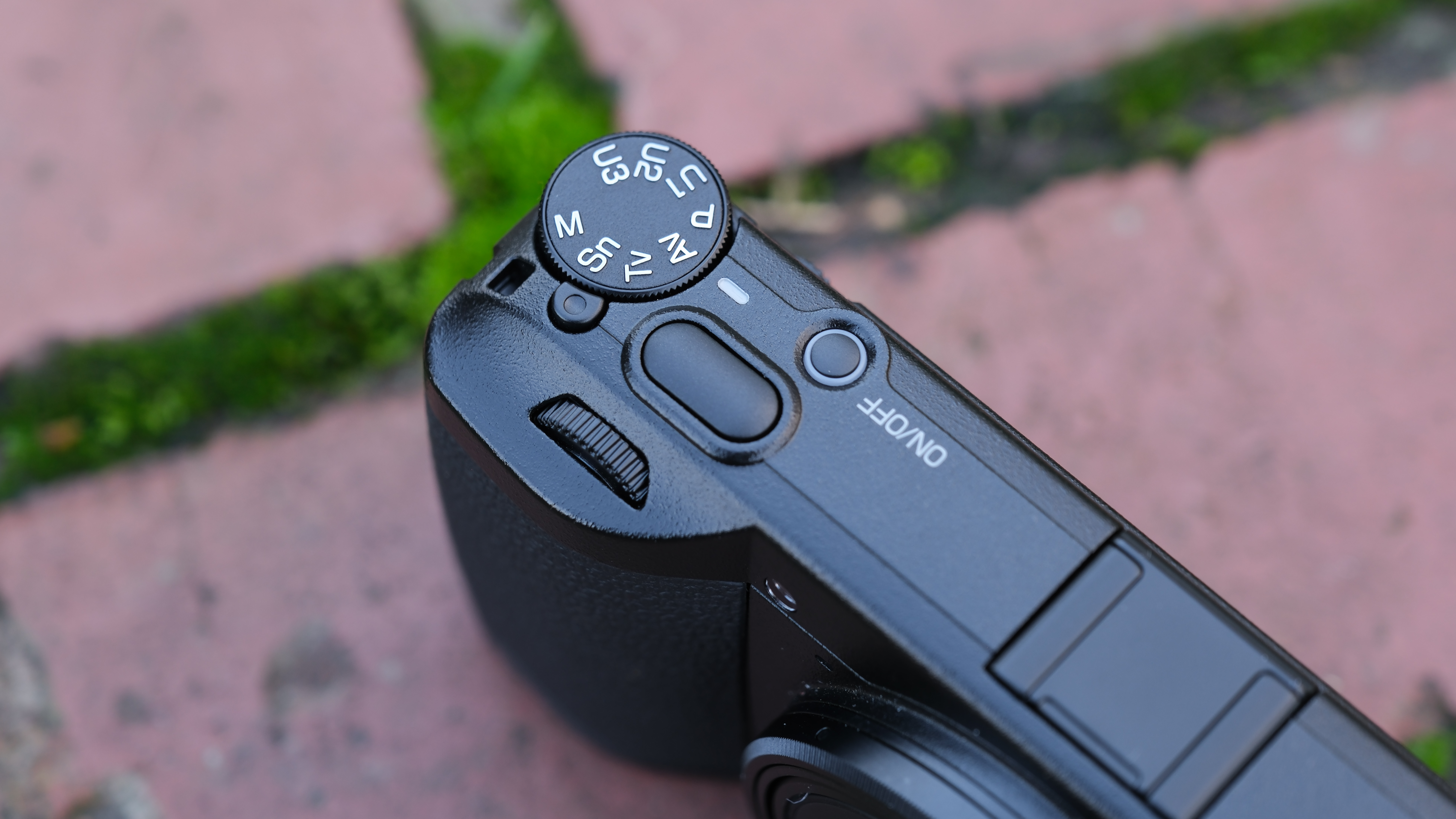 Close up of the mode dial on a Ricoh GR IV compact camera