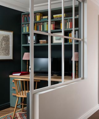 home office with dark green walls and white Crittall divder
