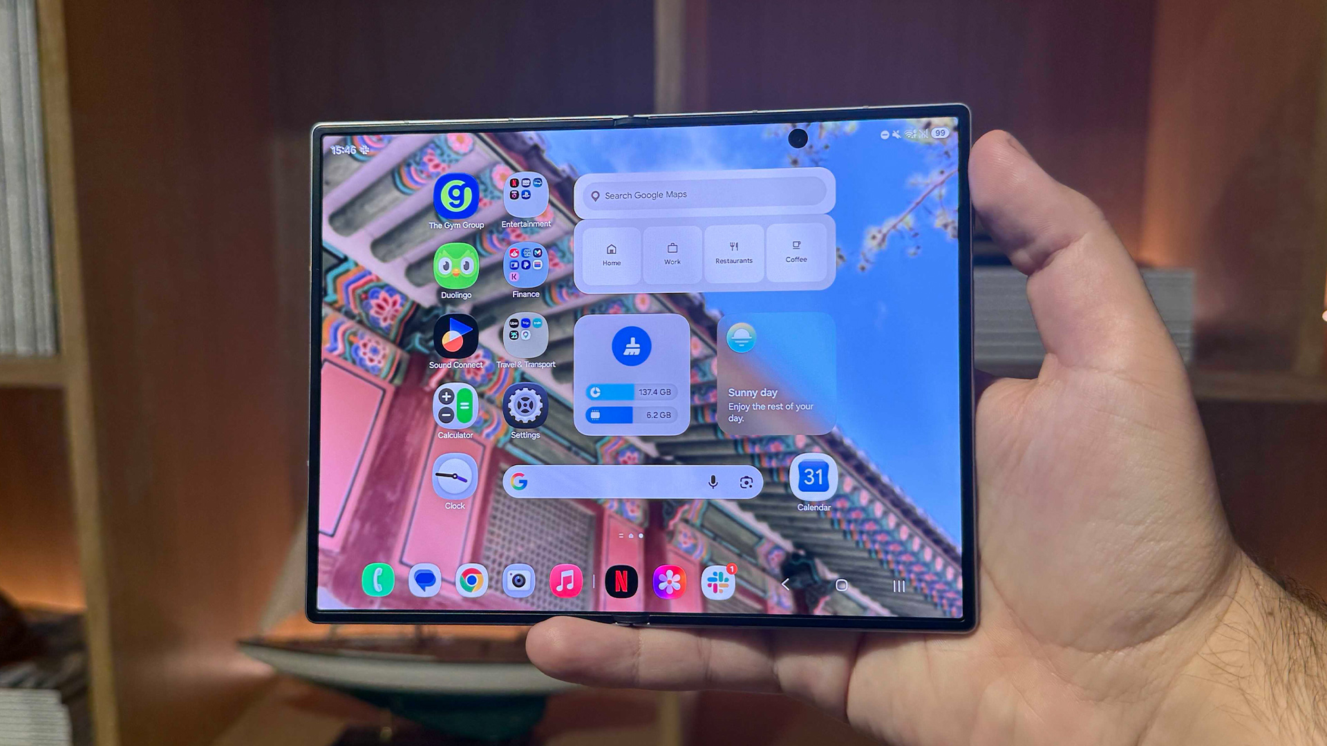 Samsung Galaxy Z Fold 8 smartphone held in hand unfolded showing app screen